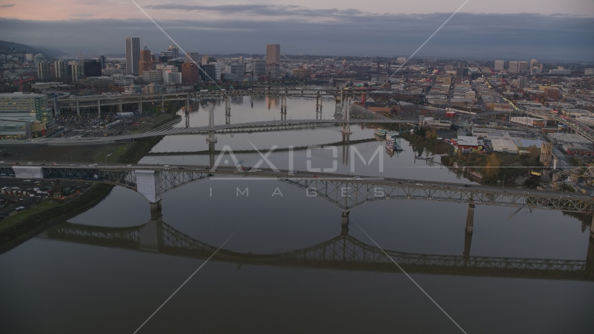 Ross Island Bridge and Willamette River bridges at sunset, reveal Downtown Portland, Oregon Aerial Stock Photo AX155_197.0000349F | Axiom Images