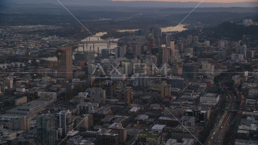 Downtown Portland cityscape by the Willamette River at sunset, Oregon Aerial Stock Photo AX155_218.0000000F | Axiom Images