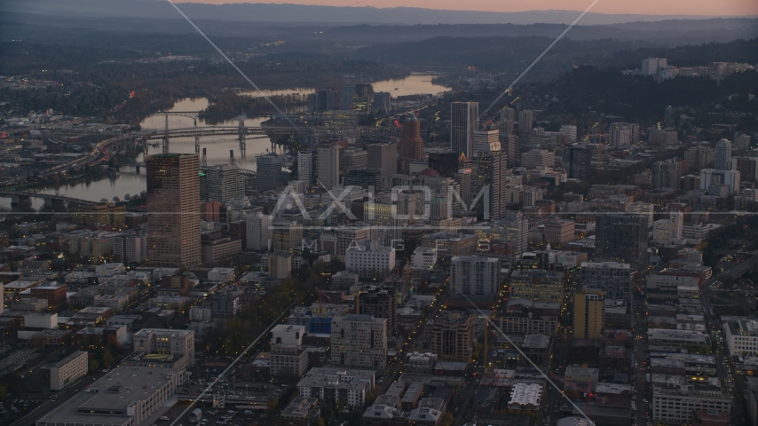 Downtown Portland cityscape by the Willamette River at sunset, Oregon Aerial Stock Photo AX155_219.0000000F | Axiom Images