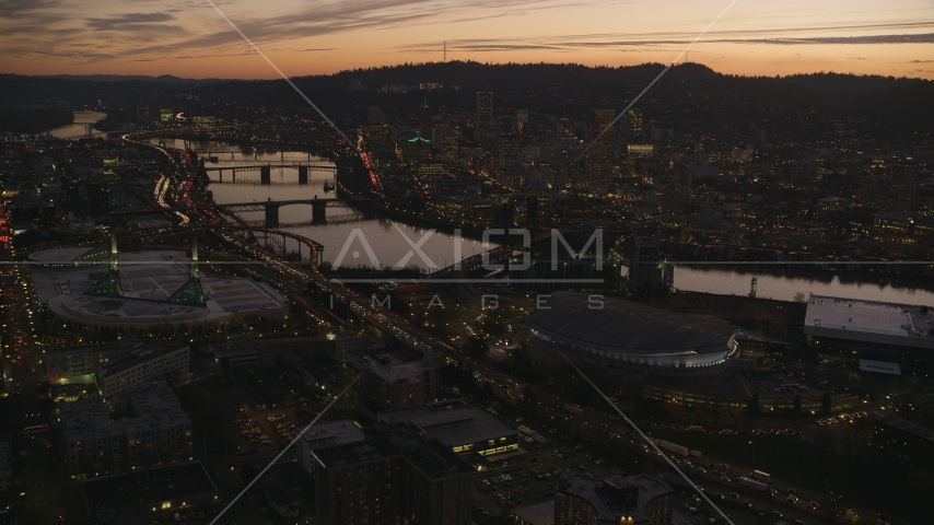 Moda Center, Willamette River, and downtown skyscrapers at sunset, Downtown Portland, Oregon Aerial Stock Photo AX155_260.0000149F | Axiom Images