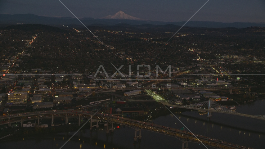 Mount Hood in the far distance, and warehouse buildings near the Willamette River, Southeast Portland, Oregon, sunset Aerial Stock Photo AX155_266.0000105F | Axiom Images