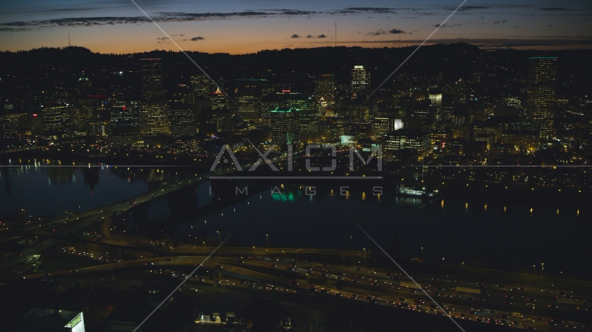Downtown Portland skyscrapers at night seen across the Willamette River, Oregon Aerial Stock Photo AX155_318.0000350F | Axiom Images