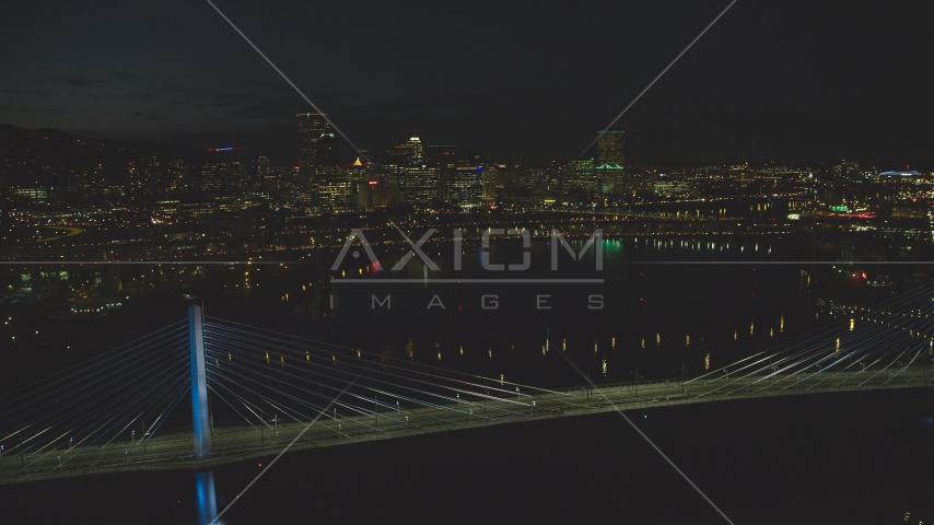 Tilikum Crossing and Marquam Bridge, with Downtown Portland skyline in the distance, Oregon, night Aerial Stock Photo AX155_325.0000188F | Axiom Images
