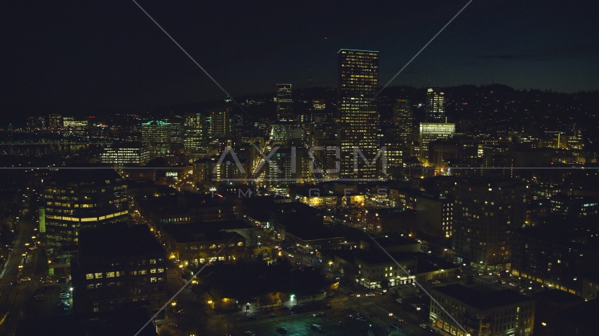 US Bancorp Tower and skyscrapers by the Willamette River at nighttime, Downtown Portland, Oregon Aerial Stock Photo AX155_366.0000310F | Axiom Images