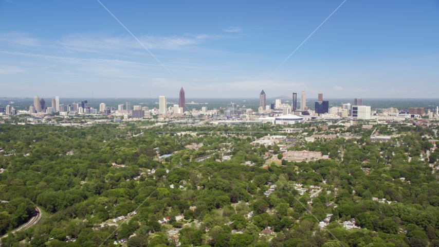 Midtown and Downtown Atlanta seen from above the trees in West Atlanta, Georgia Aerial Stock Photo AX37_006.0000258F | Axiom Images