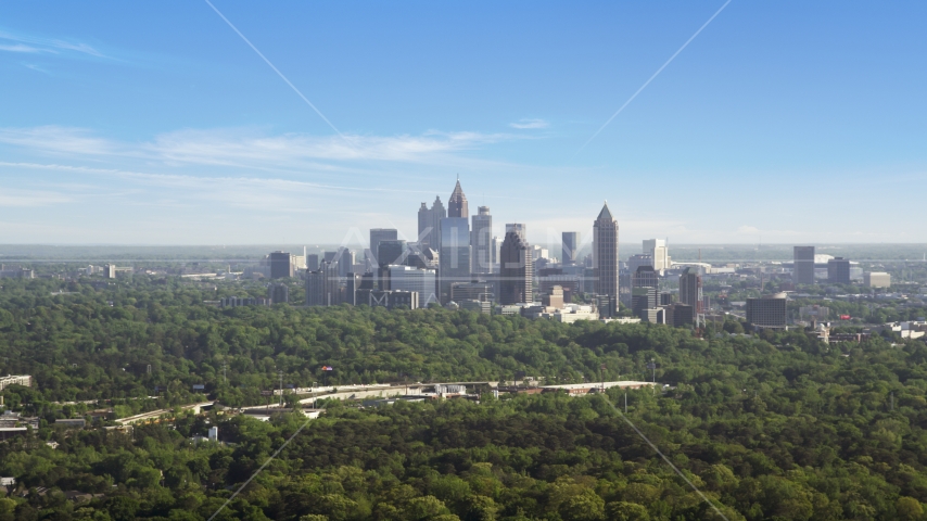 Distant shot of Midtown Atlanta skyscrapers beyond trees, Buckhead, Georgia Aerial Stock Photo AX38_027.0000048F | Axiom Images