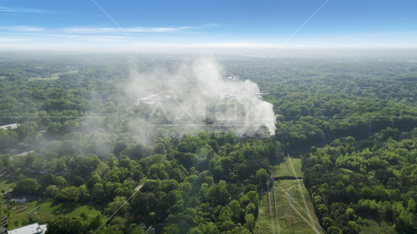 Smoke rising from a house fire in a wooded area, West Atlanta, Georgia Aerial Stock Photo AX38_048.0000129F | Axiom Images