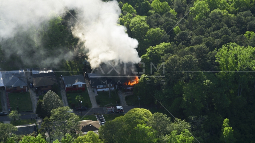 Smoke and flames from a burning home, West Atlanta, Georgia Aerial Stock Photo AX38_052.0000276F | Axiom Images