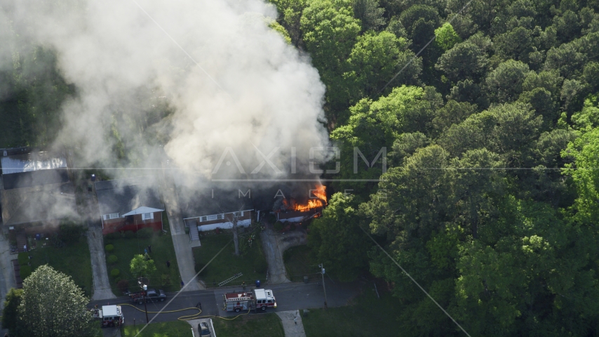 Looking down on a burning home with smoke rising, West Atlanta, Georgia Aerial Stock Photo AX38_053.0000016F | Axiom Images