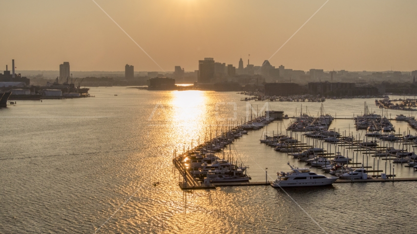 Downtown Baltimore skyline at sunset, seen from Baltimore Marine Center, Maryland Aerial Stock Photo AXP073_000_0022F | Axiom Images
