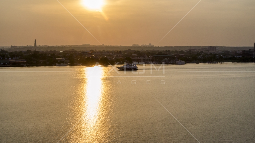 A ferry sailing the Potomac River, Alexandria, Virginia, sunset Aerial Stock Photo AXP076_000_0002F | Axiom Images