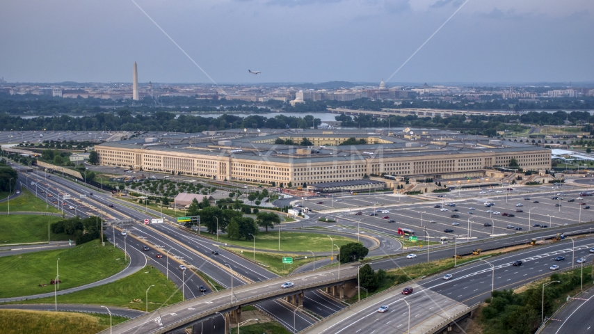 The Pentagon at twilight in Washington, D.C., with the Washington Monument in the distance Aerial Stock Photo AXP076_000_0024F | Axiom Images