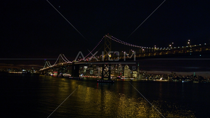 The Bay Bridge in front of the Downtown San Francisco skyline, California, night Aerial Stock Photo DCSF06_002.0000085 | Axiom Images