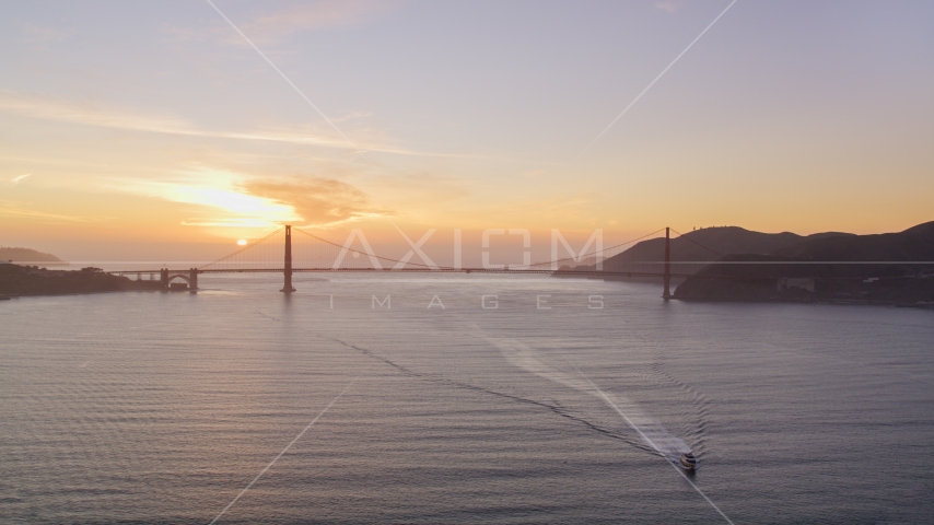 Setting sun behind the Golden Gate Bridge, San Francisco, California, sunset Aerial Stock Photo DCSF10_025.0000033 | Axiom Images