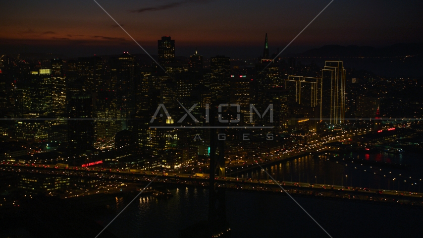 Heavy traffic on the Bay Bridge by Downtown San Francisco skyscrapers, California, night Aerial Stock Photo DCSF10_071.0000539 | Axiom Images
