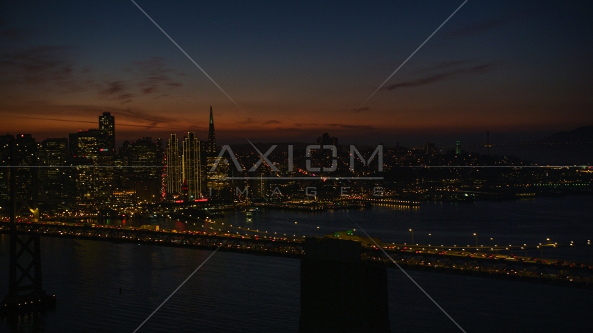 The Bay Bridge with San Francisco skyline in the background, California, night Aerial Stock Photo DCSF10_072.0000075 | Axiom Images