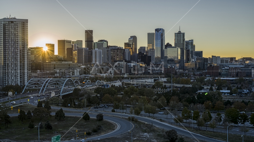 The city skyline with the bright sun rising behind the skyscrapers in Downtown Denver, Colorado Aerial Stock Photo DXP001_000099 | Axiom Images