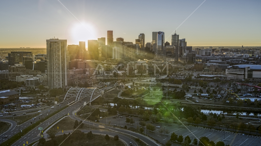 The city skyline with the bright sun rising above the skyscrapers in Downtown Denver, Colorado Aerial Stock Photo DXP001_000100 | Axiom Images