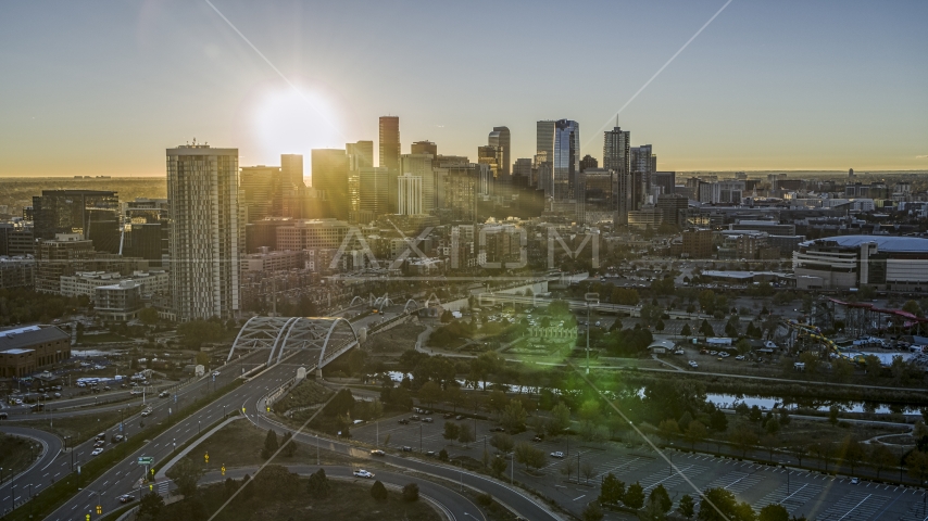 The city skyline with the bright sun above the skyscrapers at sunrise in Downtown Denver, Colorado Aerial Stock Photo DXP001_000101 | Axiom Images