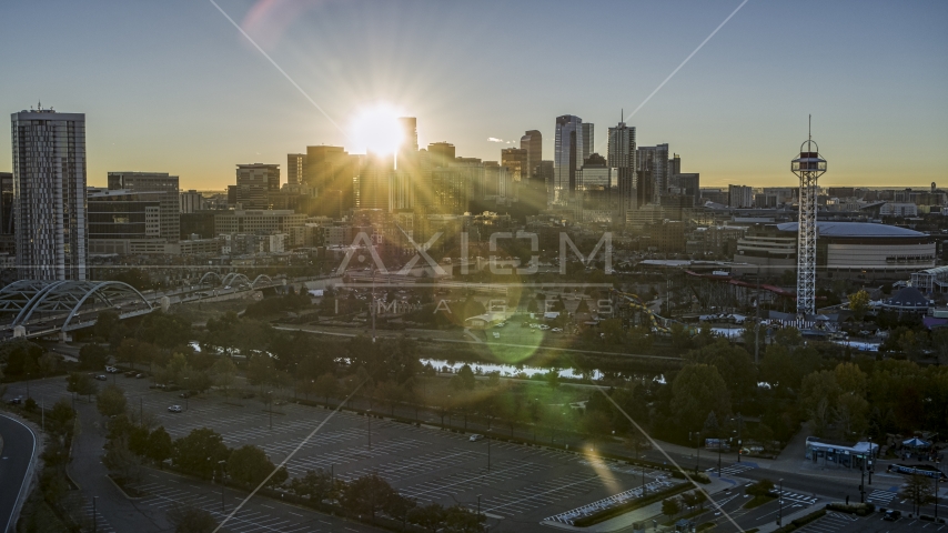The city skyline with the bright sun behind the skyscrapers at sunrise in Downtown Denver, Colorado Aerial Stock Photo DXP001_000102 | Axiom Images