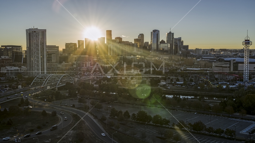 The city skyline with the sun behind the skyscrapers at sunrise in Downtown Denver, Colorado Aerial Stock Photo DXP001_000103 | Axiom Images