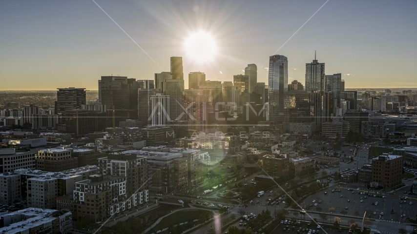 The sun shining above the skyscrapers of the city's skyline at sunrise in Downtown Denver, Colorado Aerial Stock Photo DXP001_000106 | Axiom Images