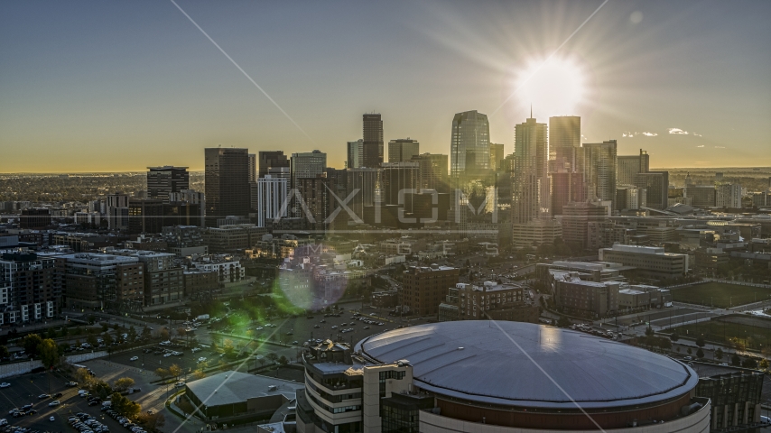 The sun shining above the skyscrapers of the city's skyline at sunrise, seen from arena in Downtown Denver, Colorado Aerial Stock Photo DXP001_000107 | Axiom Images