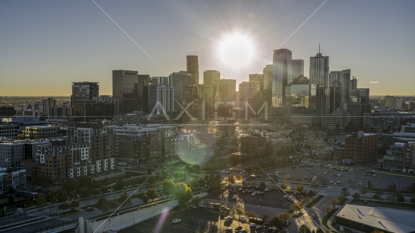 City's skyline with sun shining above skyscrapers at sunrise, Downtown Denver, Colorado Aerial Stock Photo DXP001_000115 | Axiom Images
