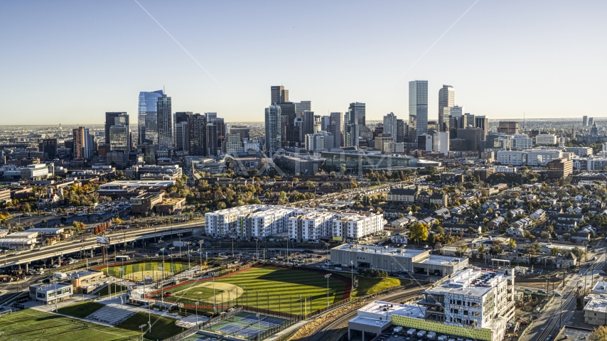 City skyline in the background behind apartment buildings and sports fields, Downtown Denver, Colorado Aerial Stock Photo DXP001_000120 | Axiom Images