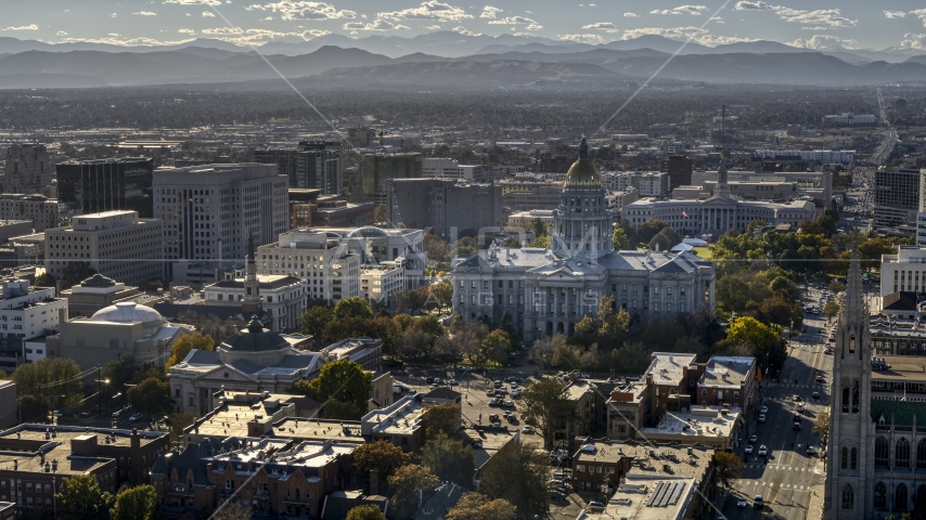 The Colorado State Capitol and nearby buildings, mountains in background, Downtown Denver, Colorado Aerial Stock Photo DXP001_000176 | Axiom Images