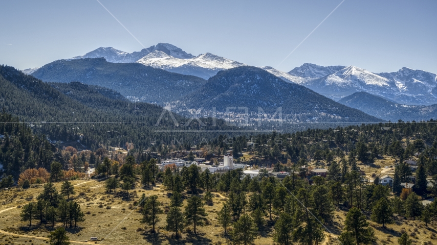 A small town with snowy mountains visible in the background in Estes Park, Colorado Aerial Stock Photo DXP001_000216 | Axiom Images