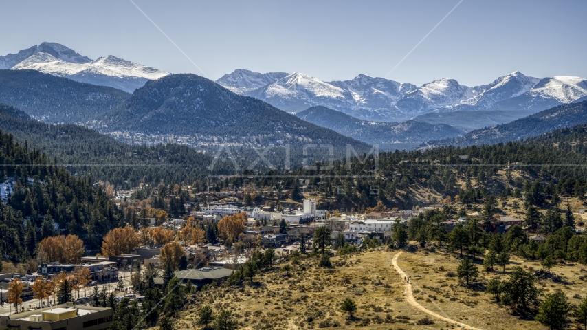 A small town with snowy mountains visible in the distance in Estes Park, Colorado Aerial Stock Photo DXP001_000217 | Axiom Images
