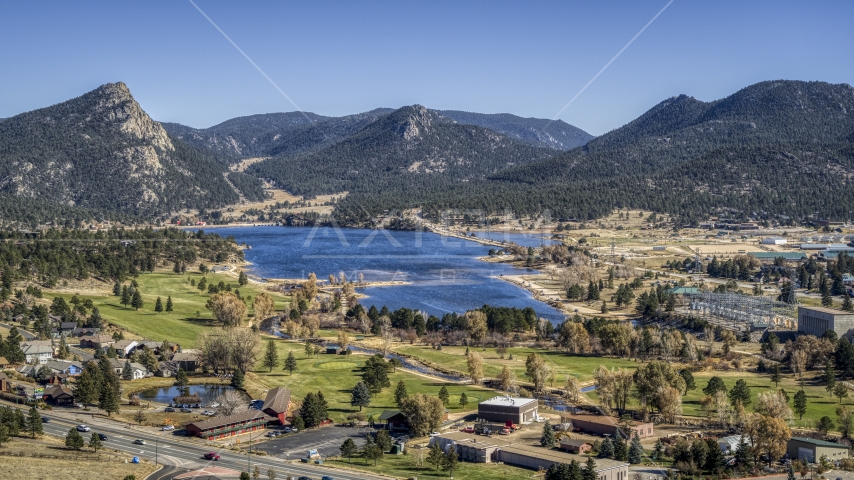 Golf course next to Lake Estes with mountains in the background in Estes Park, Colorado Aerial Stock Photo DXP001_000220 | Axiom Images