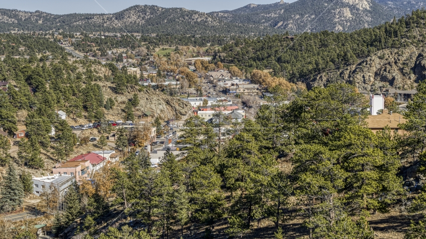 Shops on a road through Estes Park, Colorado seen from trees on a hill Aerial Stock Photo DXP001_000222 | Axiom Images