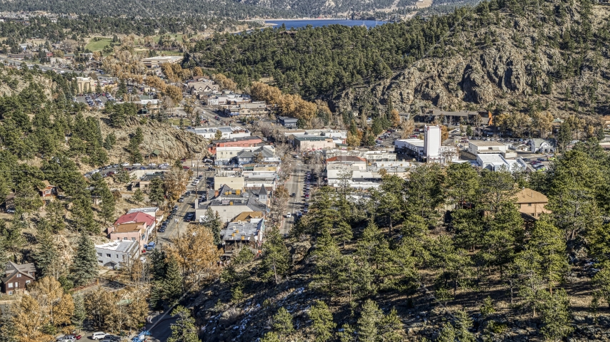Shops on a road through Estes Park, Colorado, seen from a tree-covered hill Aerial Stock Photo DXP001_000225 | Axiom Images
