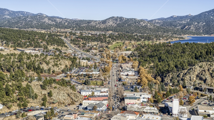 Shops on a road through town, with mountains and Lake Estes in the background, Estes Park, Colorado Aerial Stock Photo DXP001_000226 | Axiom Images