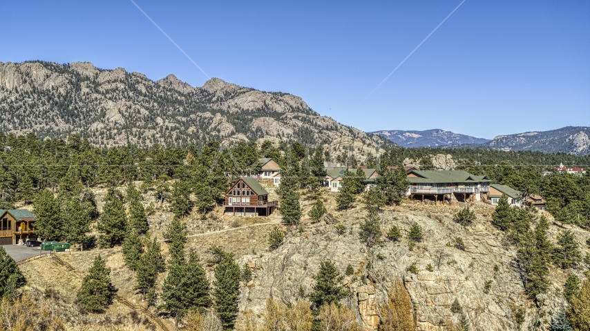 Rural hillside homes near rugged mountains, Estes Park, Colorado Aerial Stock Photo DXP001_000229 | Axiom Images