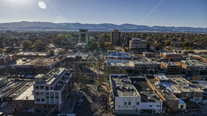 Taller office buildings and shops, mountains in the background in Fort Collins, Colorado Aerial Stock Photo DXP001_000233 | Axiom Images