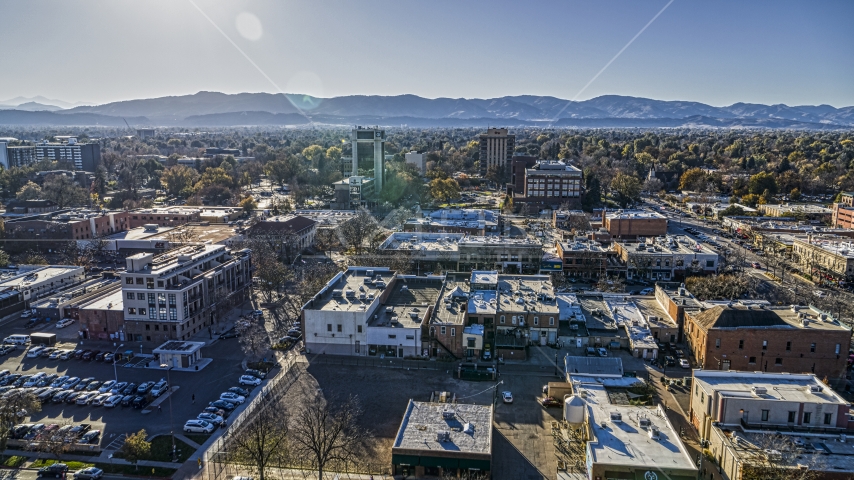 Shops with taller office buildings and mountains in the background in Fort Collins, Colorado Aerial Stock Photo DXP001_000234 | Axiom Images