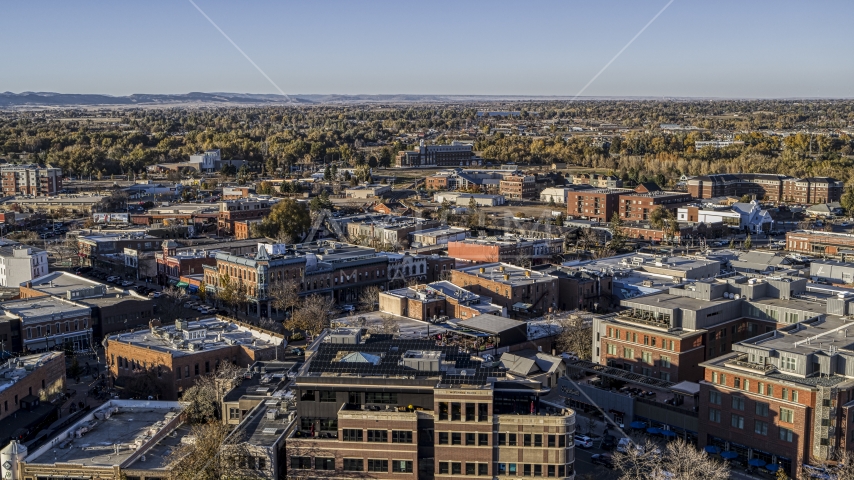 A view across the tops of brick office buildings and small shops in Fort Collins, Colorado Aerial Stock Photo DXP001_000247 | Axiom Images