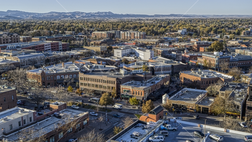 Shops and brick office buildings lining a busy town road in Fort Collins, Colorado Aerial Stock Photo DXP001_000252 | Axiom Images