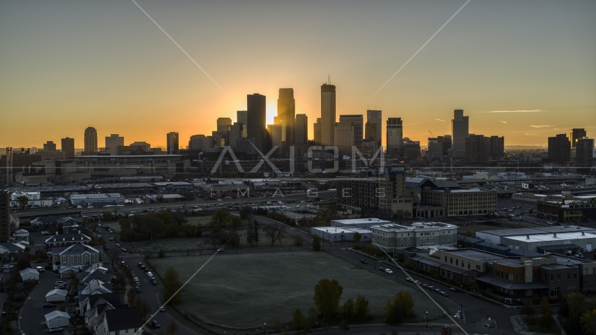 The rising sun behind skyscrapers in the city's skyline in Downtown Minneapolis, Minnesota Aerial Stock Photo DXP001_000260 | Axiom Images