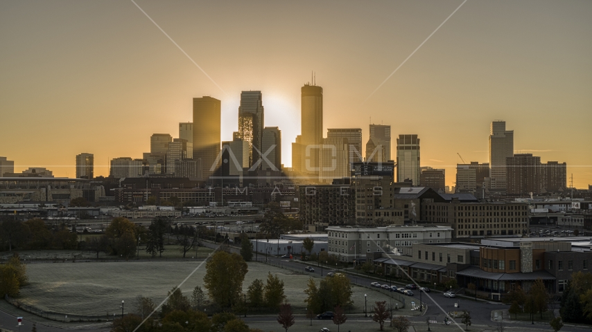 The rising sun glowing behind tall skyscrapers in the city's skyline in Downtown Minneapolis, Minnesota Aerial Stock Photo DXP001_000266 | Axiom Images