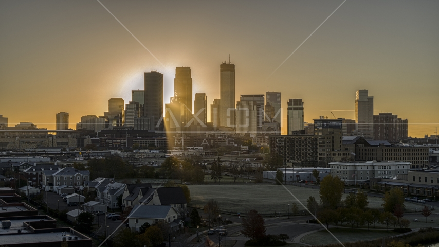 The rising sun glowing behind giant skyscrapers in the city's skyline in Downtown Minneapolis, Minnesota Aerial Stock Photo DXP001_000267 | Axiom Images