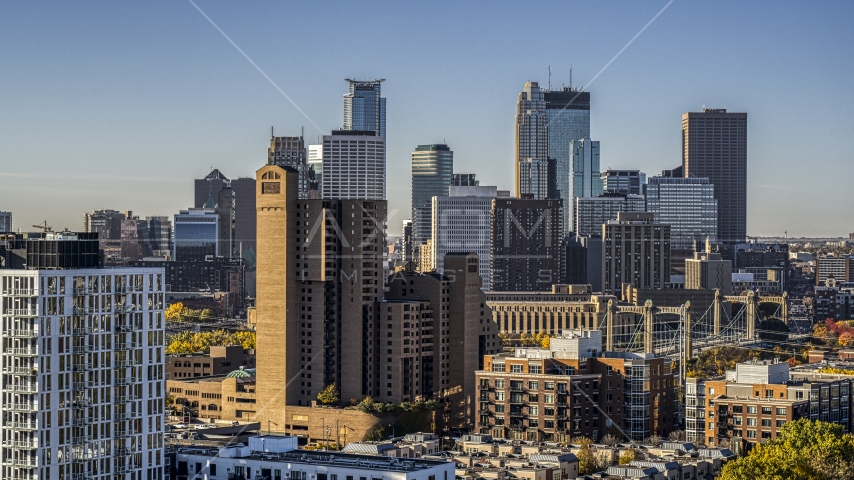 The city skyline's skyscrapers at sunrise seen from treetops in Downtown Minneapolis, Minnesota Aerial Stock Photo DXP001_000279 | Axiom Images