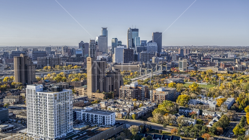Condo complex in the foreground, city skyline's skyscrapers in the background at sunrise, Downtown Minneapolis, Minnesota Aerial Stock Photo DXP001_000285 | Axiom Images