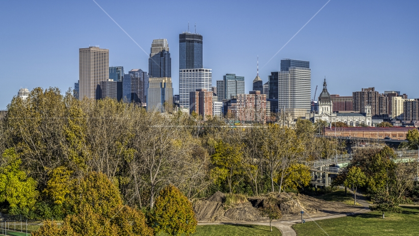 The city's skyline seen from trees at a nearby park, Downtown Minneapolis, Minnesota Aerial Stock Photo DXP001_000311 | Axiom Images