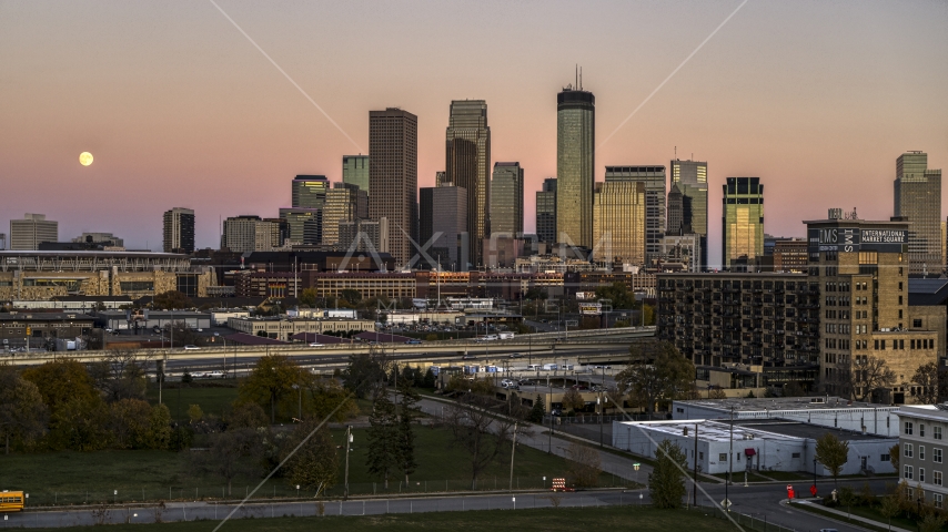 The moon in the sky beside the city's skyline at twilight in Downtown Minneapolis, Minnesota Aerial Stock Photo DXP001_000328 | Axiom Images