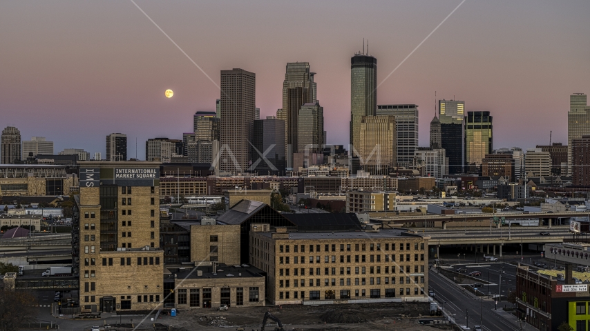 The moon in the sky near the city's skyline at twilight, marketplace building in the foreground, Downtown Minneapolis, Minnesota Aerial Stock Photo DXP001_000330 | Axiom Images