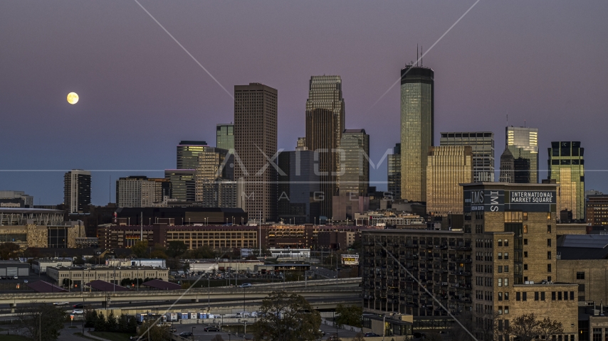 The moon in the sky beside the giant skyscrapers of the city's skyline at twilight, Downtown Minneapolis, Minnesota Aerial Stock Photo DXP001_000334 | Axiom Images